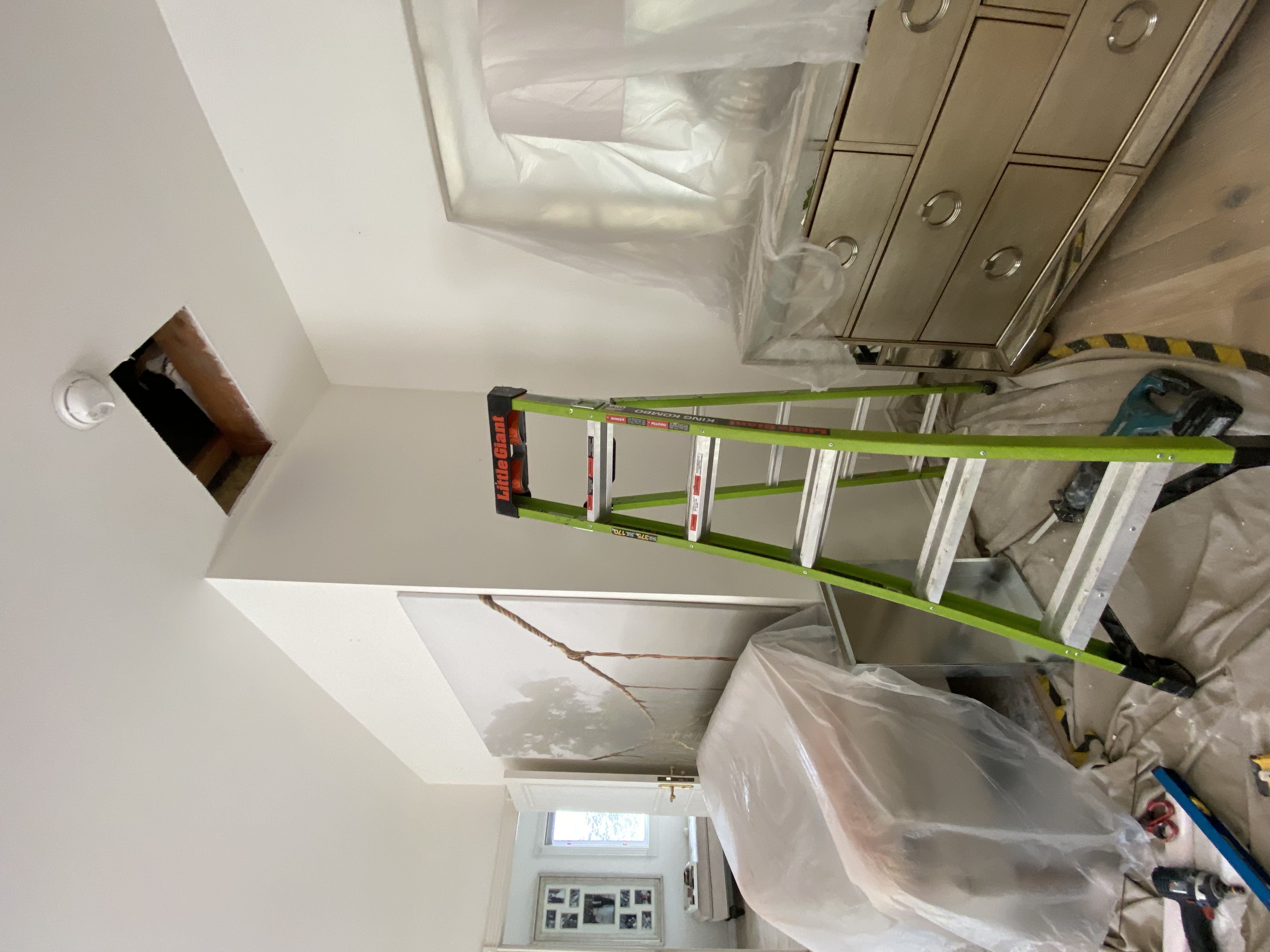 Technician accessing attic space during a furnace installation